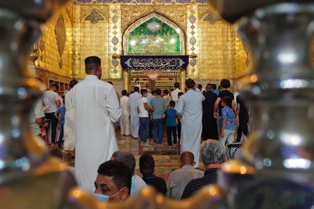 رجال عراقيون يقفون في محيط ضريح الإمام على بن أبي طالب